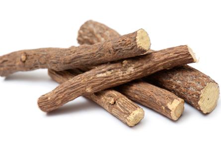 Bundle of dried licorice roots, traditionally used for their sweet flavor and potential support for digestive health.