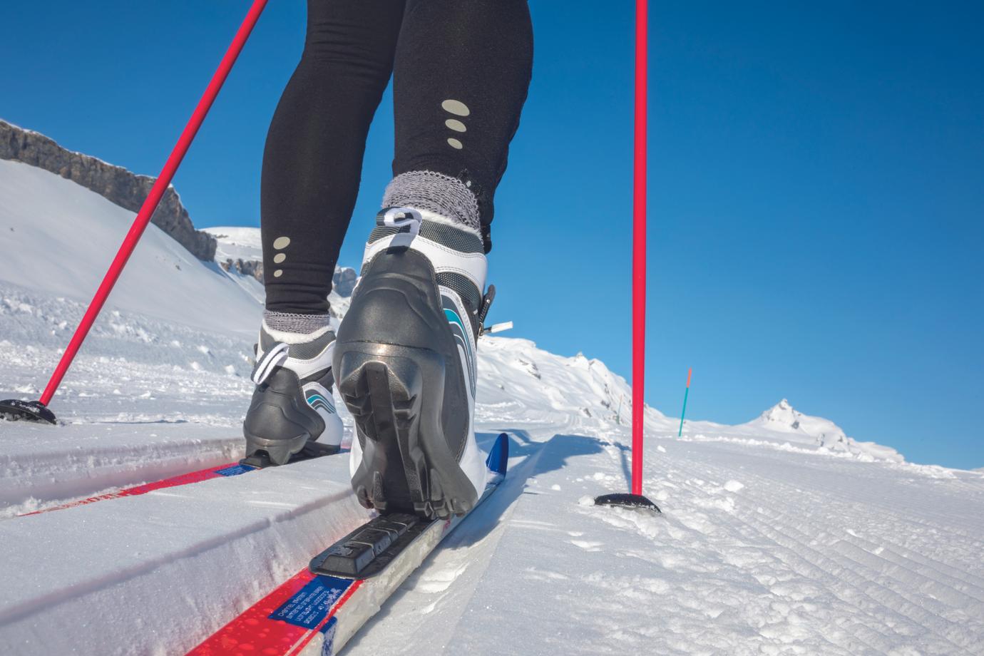 Cross-country skiing: young woman cross-country skiing on a winter day (motion blurred image)