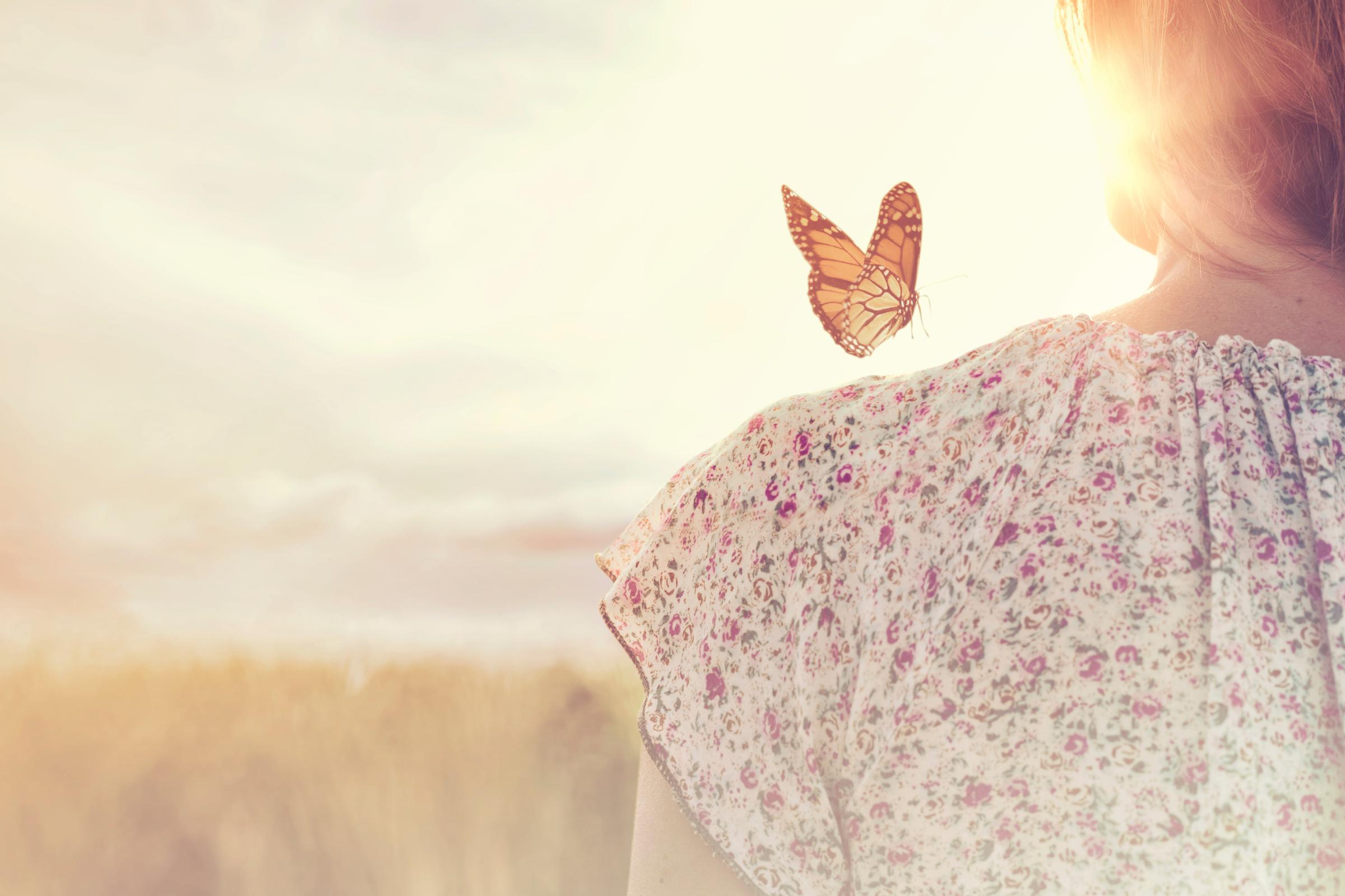 Butterfly on Girl Shoulder - shutterstock