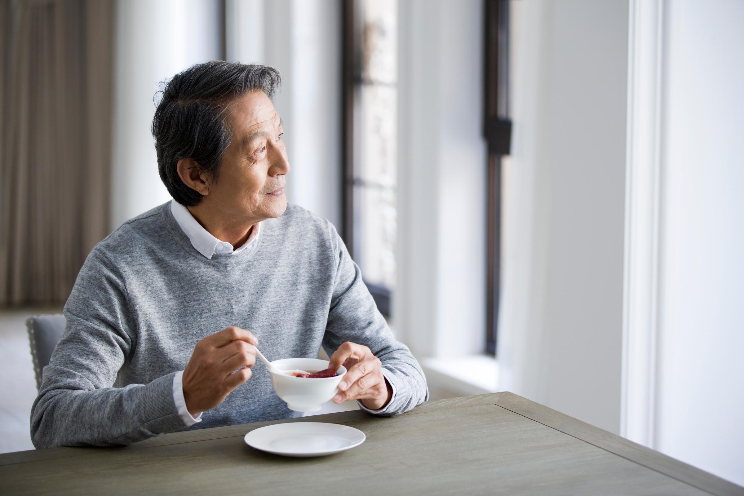 Elderly Asian Man Eating - GettyImages