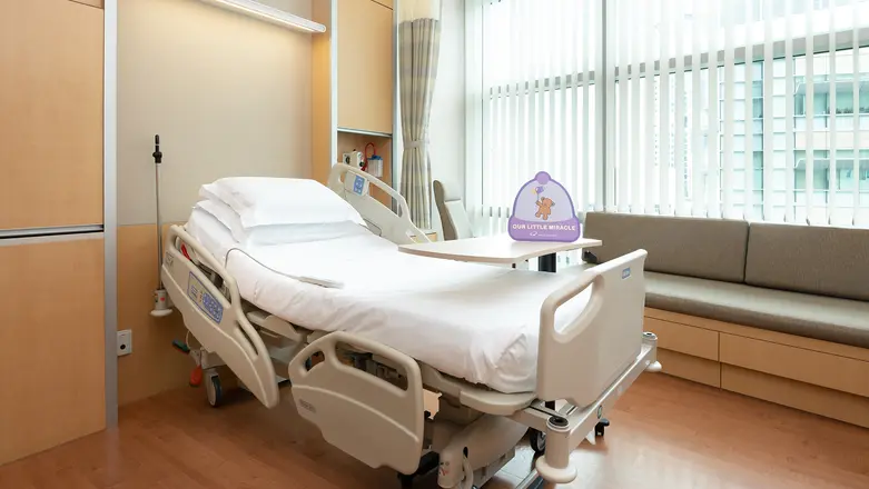 Spacious room with full-height windows in the single maternity room at Mount Elizabeth Novena Hospital