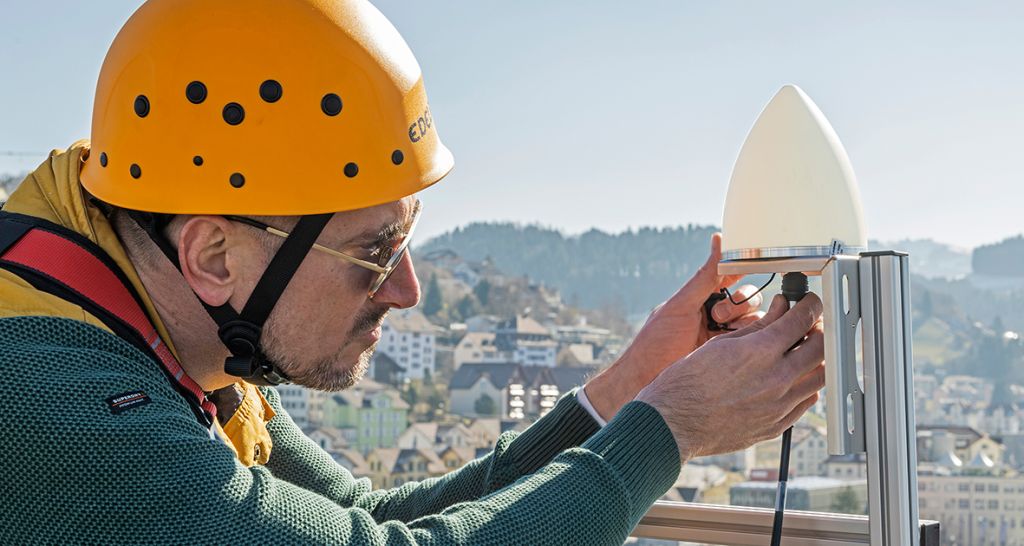 Man installing New HUBER+SUHNER SYNCRO PR antenna