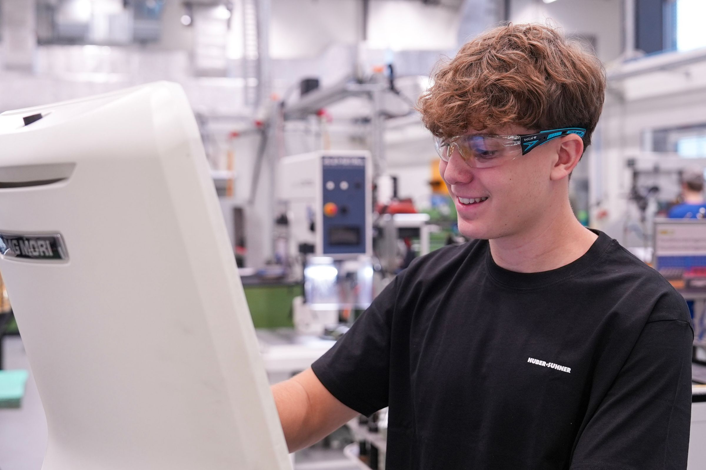young men in an industrial environment working as an machine operator