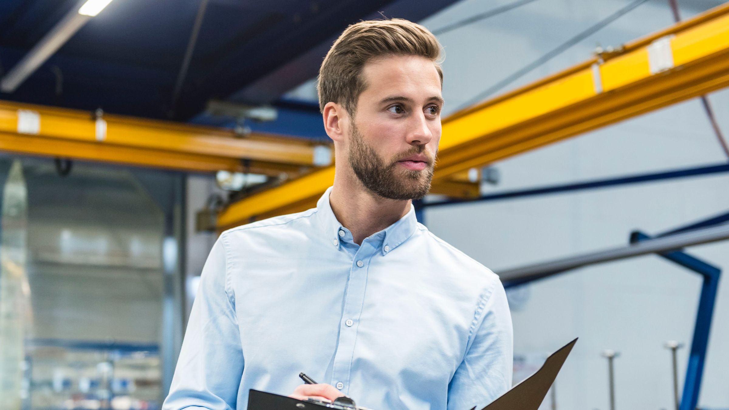 man overseeing production – coach