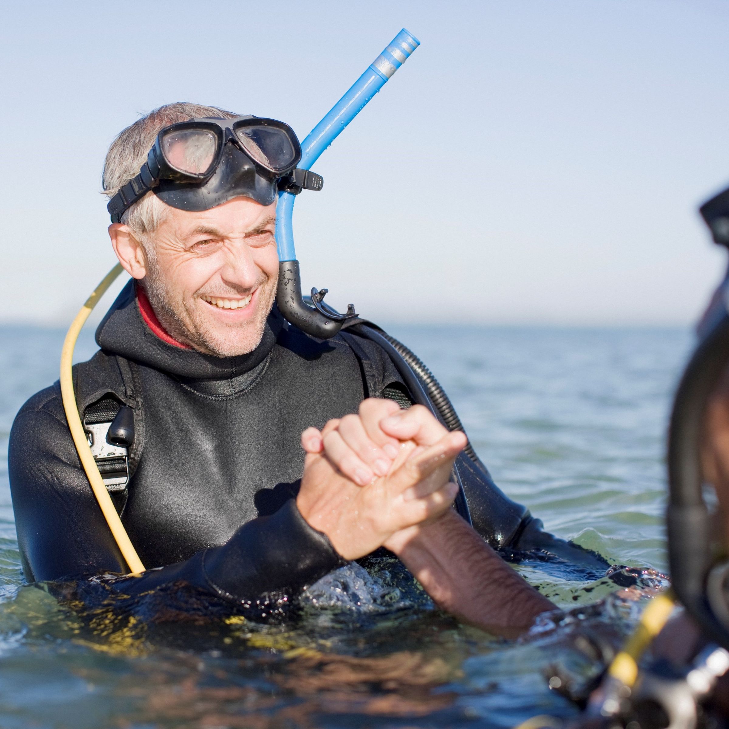 a scuba diver shaking hands – be an enabler