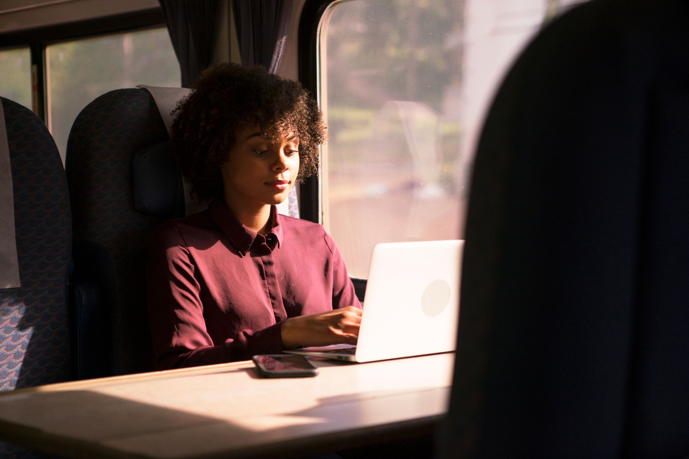 Female on train with laptop - 1155826972