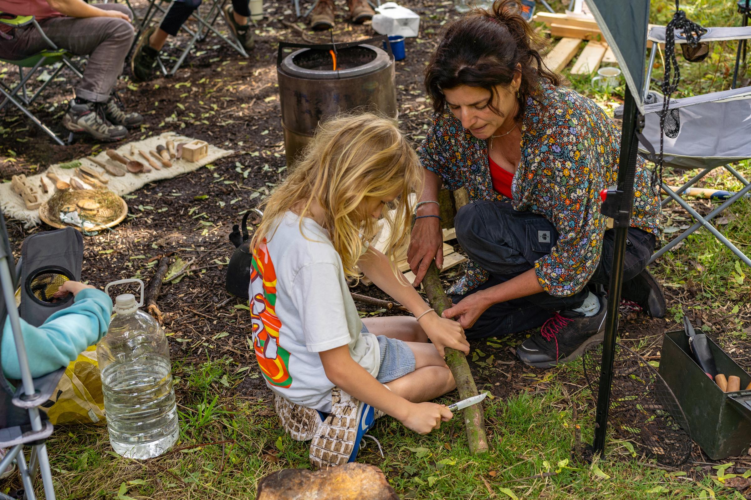 Woman and girl doing forest crafts in Homestead Park