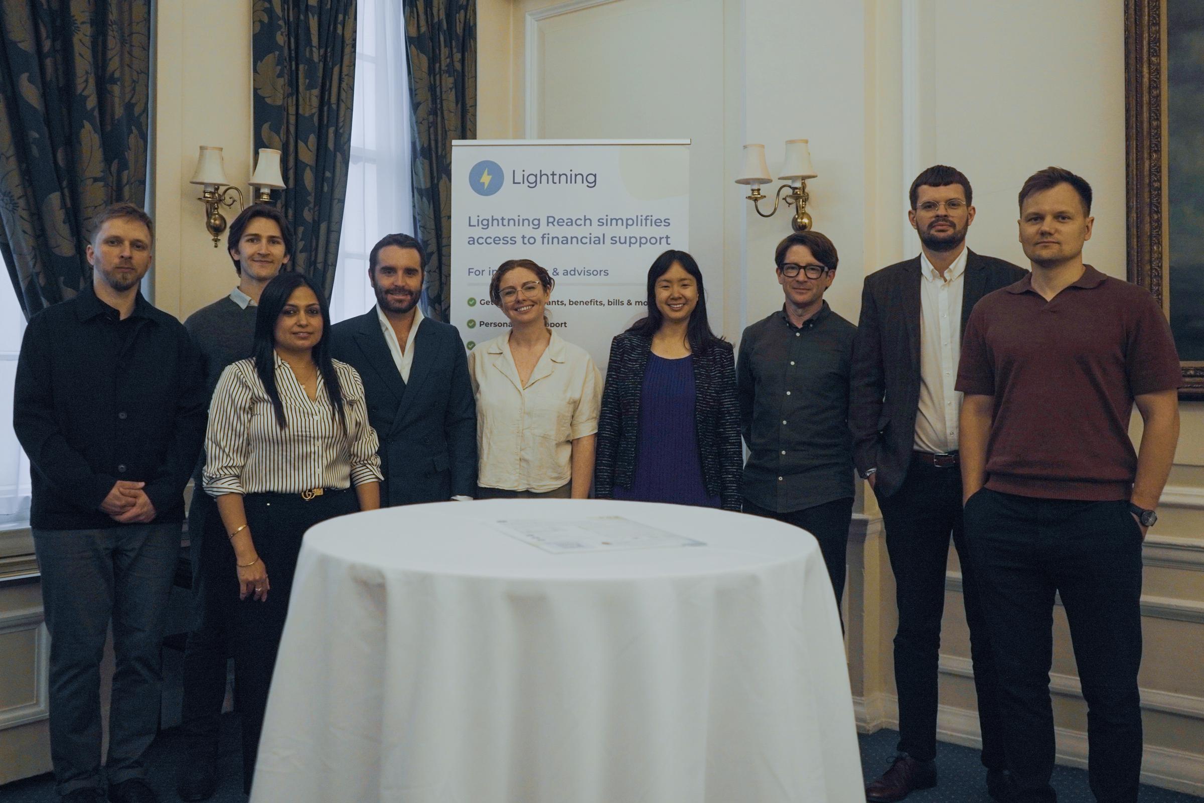 People standing in front of table smiling for photo