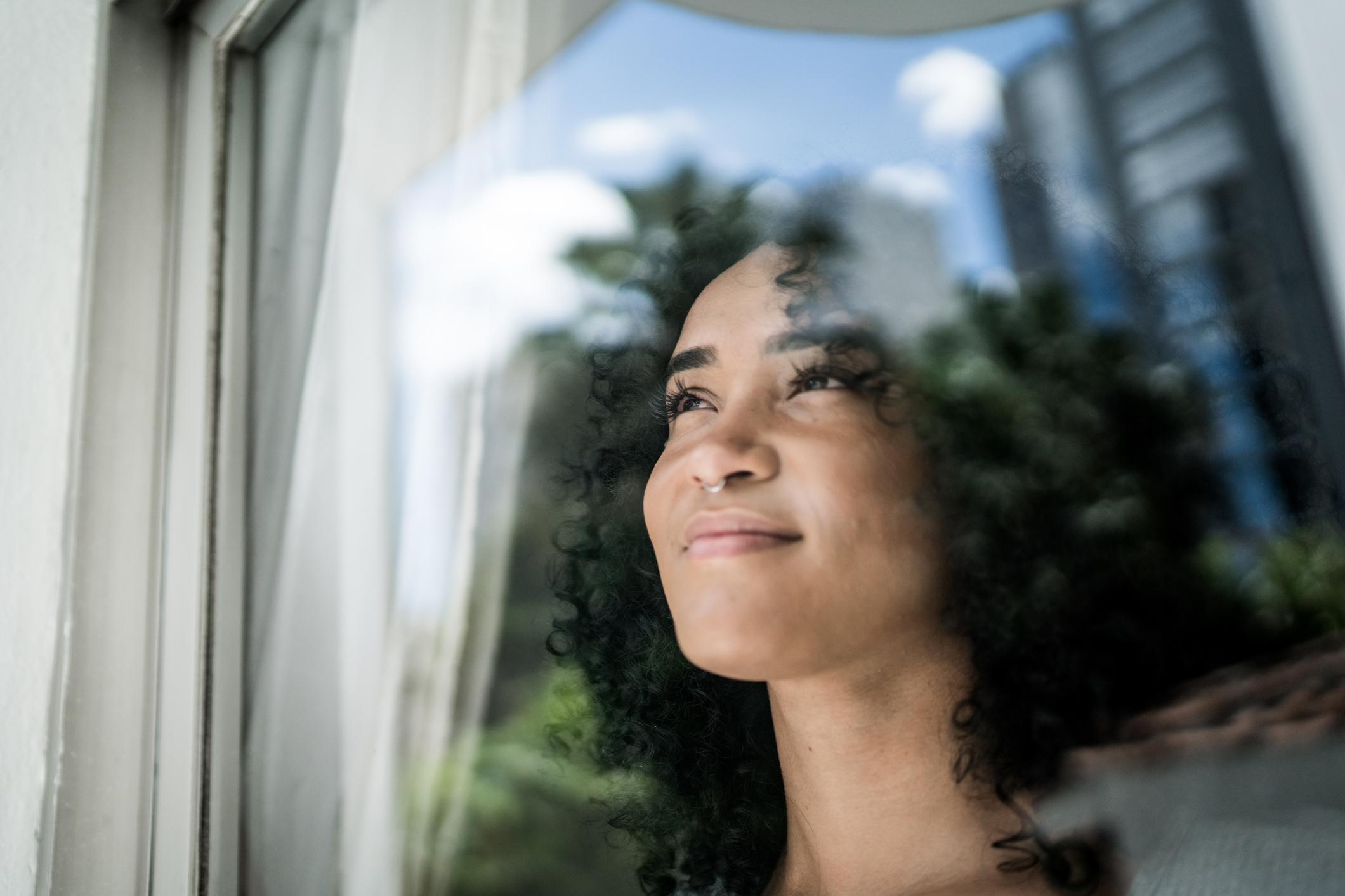 Woman looking out of a window.