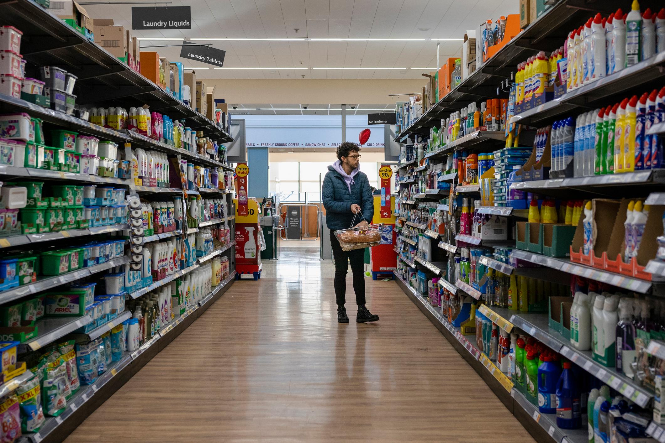 Man shopping in a budget supermarket.