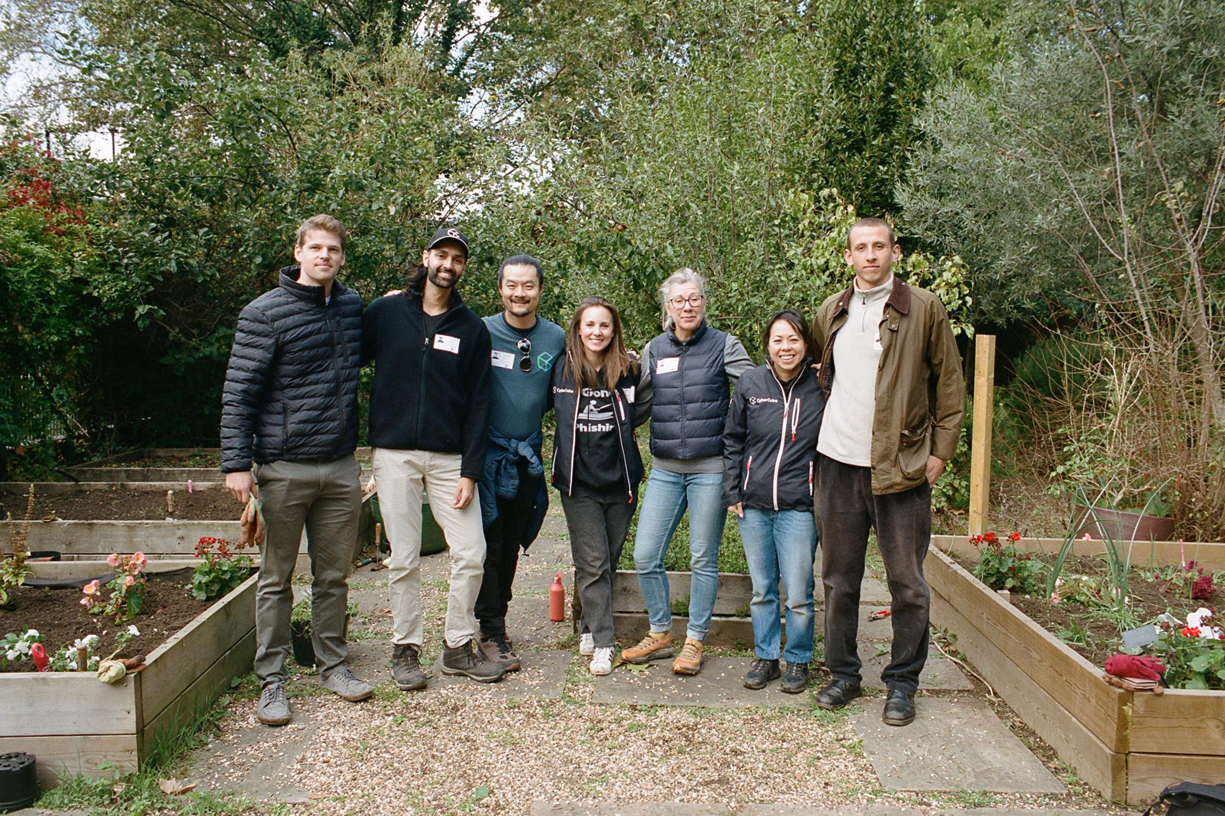 Group of volunteers standing in a school garden.