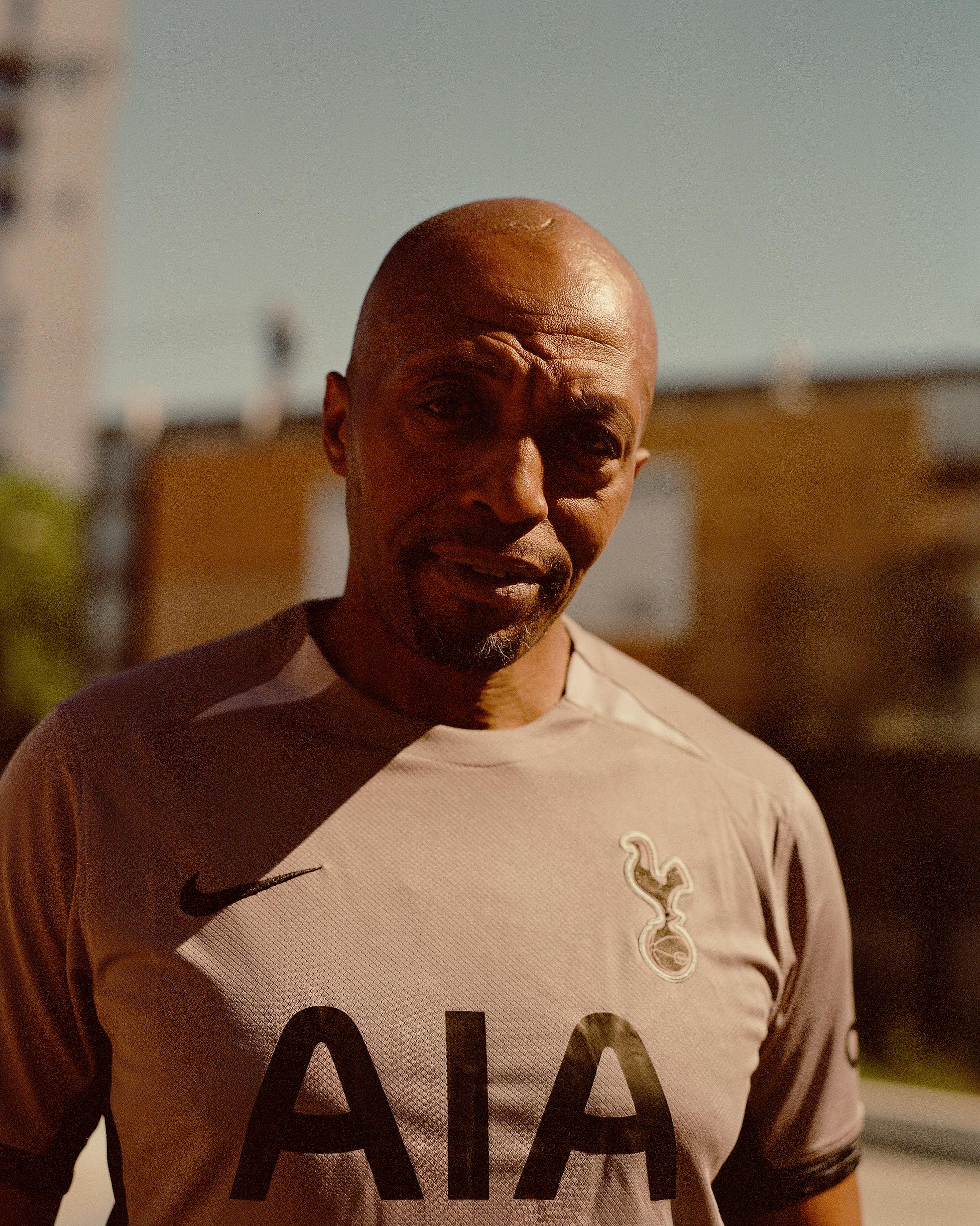 Charismatic community leader wearing football shirt 