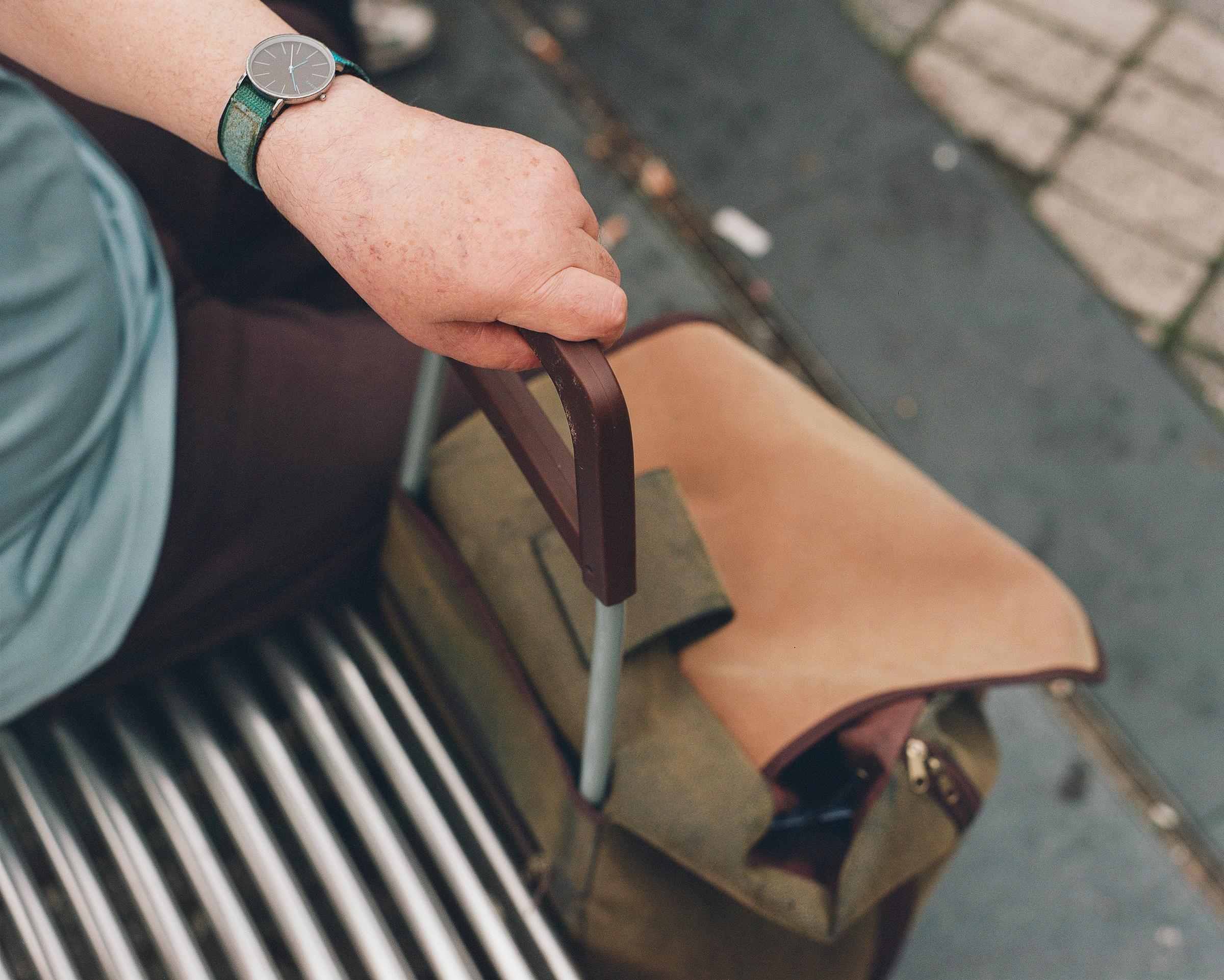 Elderly man with hand on shopping bag