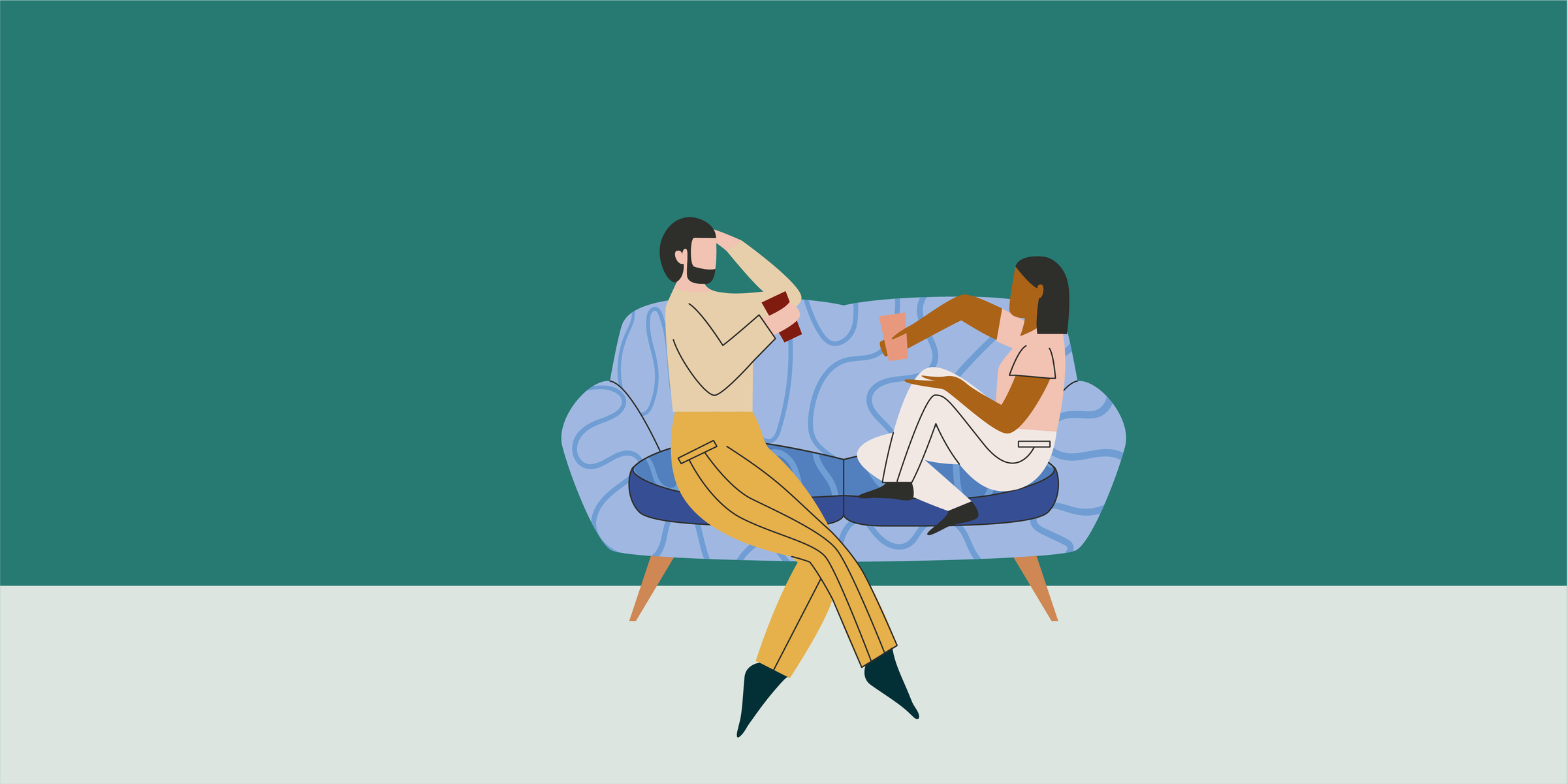 Two people sitting on a sofa talking