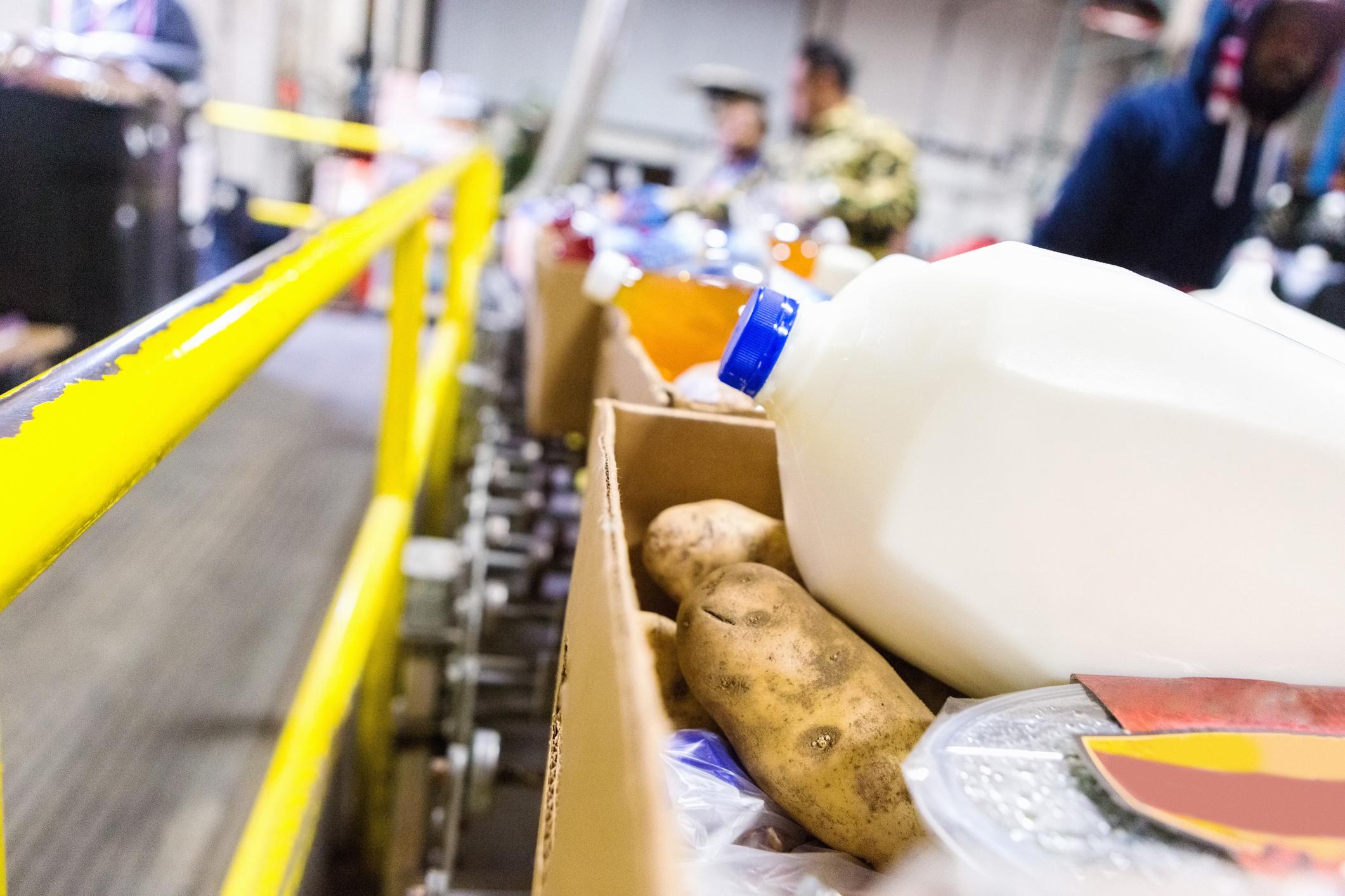 Donated groceries in boxes at a food bank.