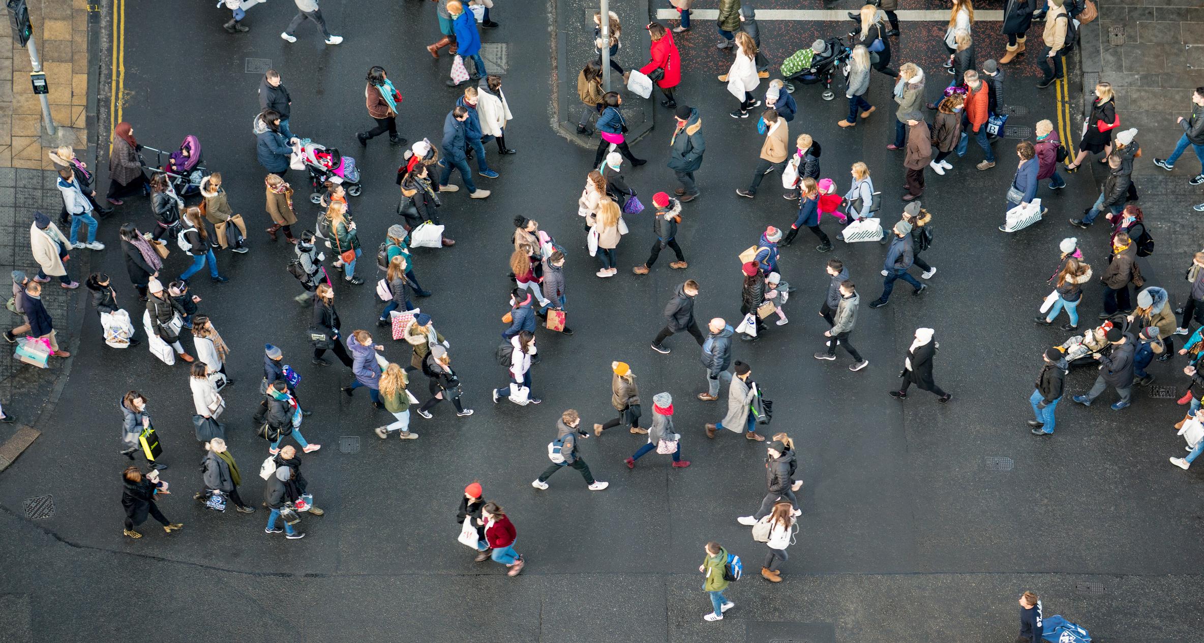 A view of British pedestrains at a road crossing, from directly above.