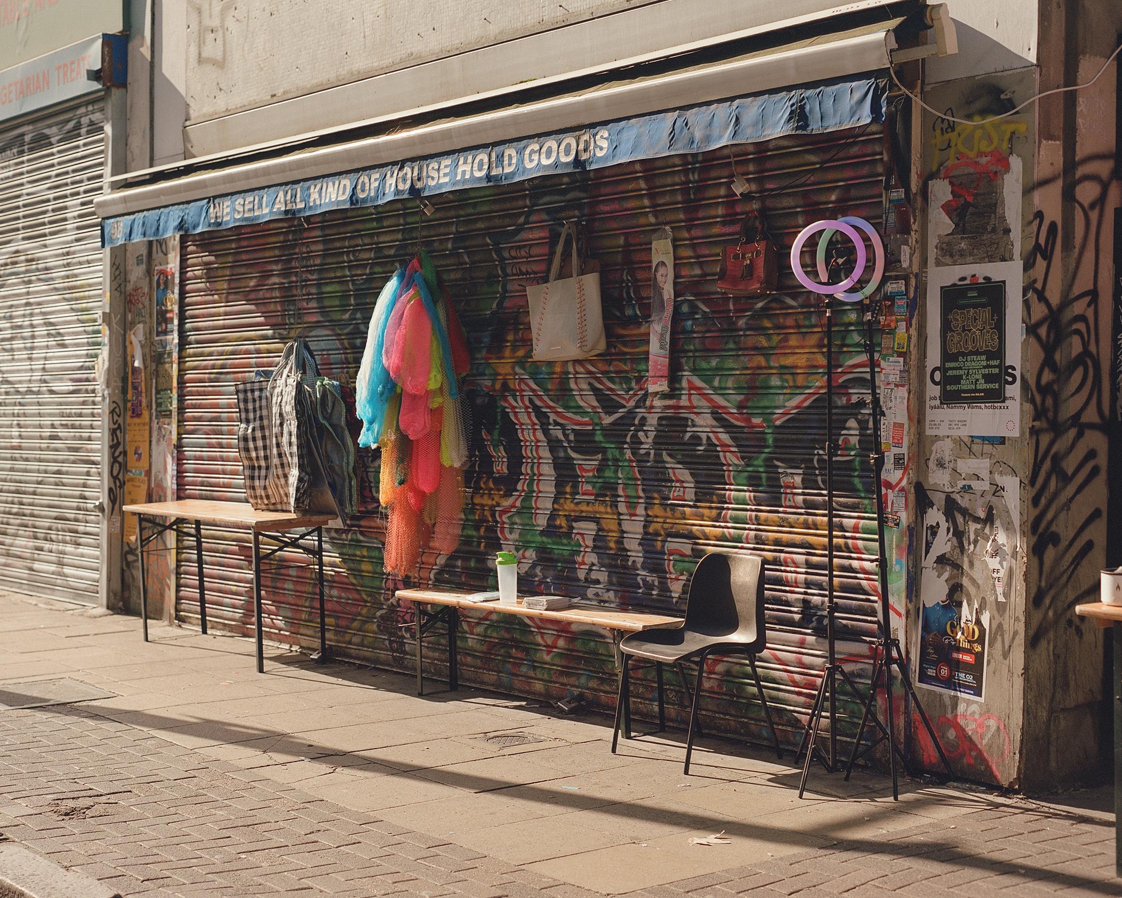 Table and items being sold in front of a closed shop.