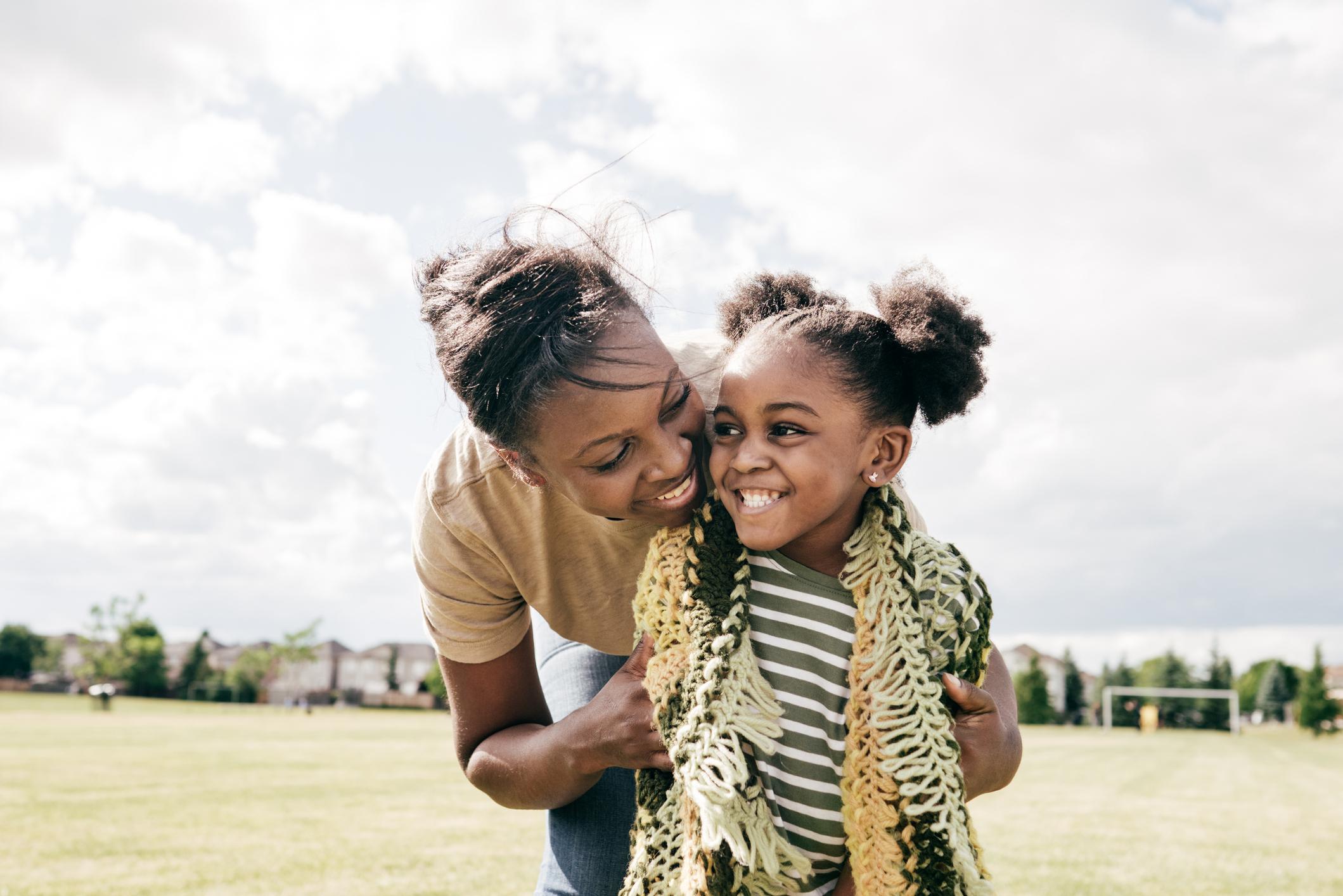 Mother and daughter smiling.