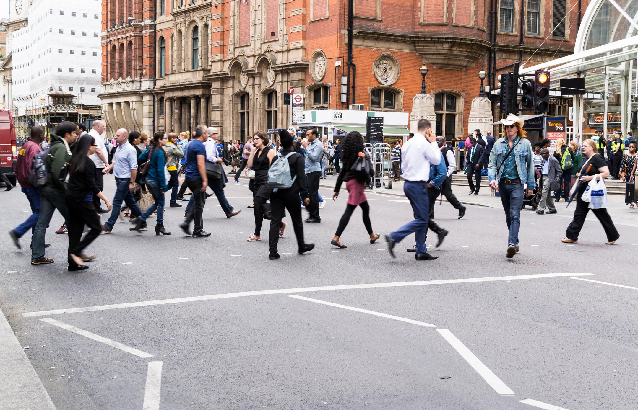Busy commuters crossing the road outside Liverpool Street Station.