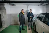Ramboll Finland brand shoot in Ramboll Village Espoo December 2021. Picture of two Ramboll employees in garage charging an electric car.