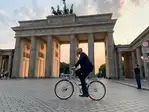 photo of cyclist in front of Brandenburg Gate