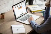 Man working at desk with laptop
