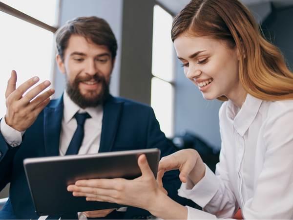 Man and woman looking at a tablet