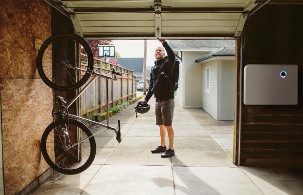 Man verlaat zijn garage, waar een slimme thuisbatterij staat
