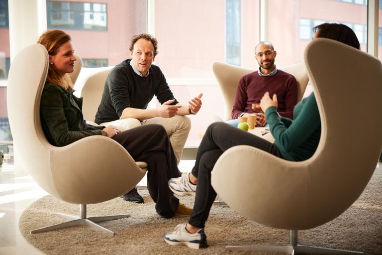 Eneco collegues talking to each other while sitting in chairs