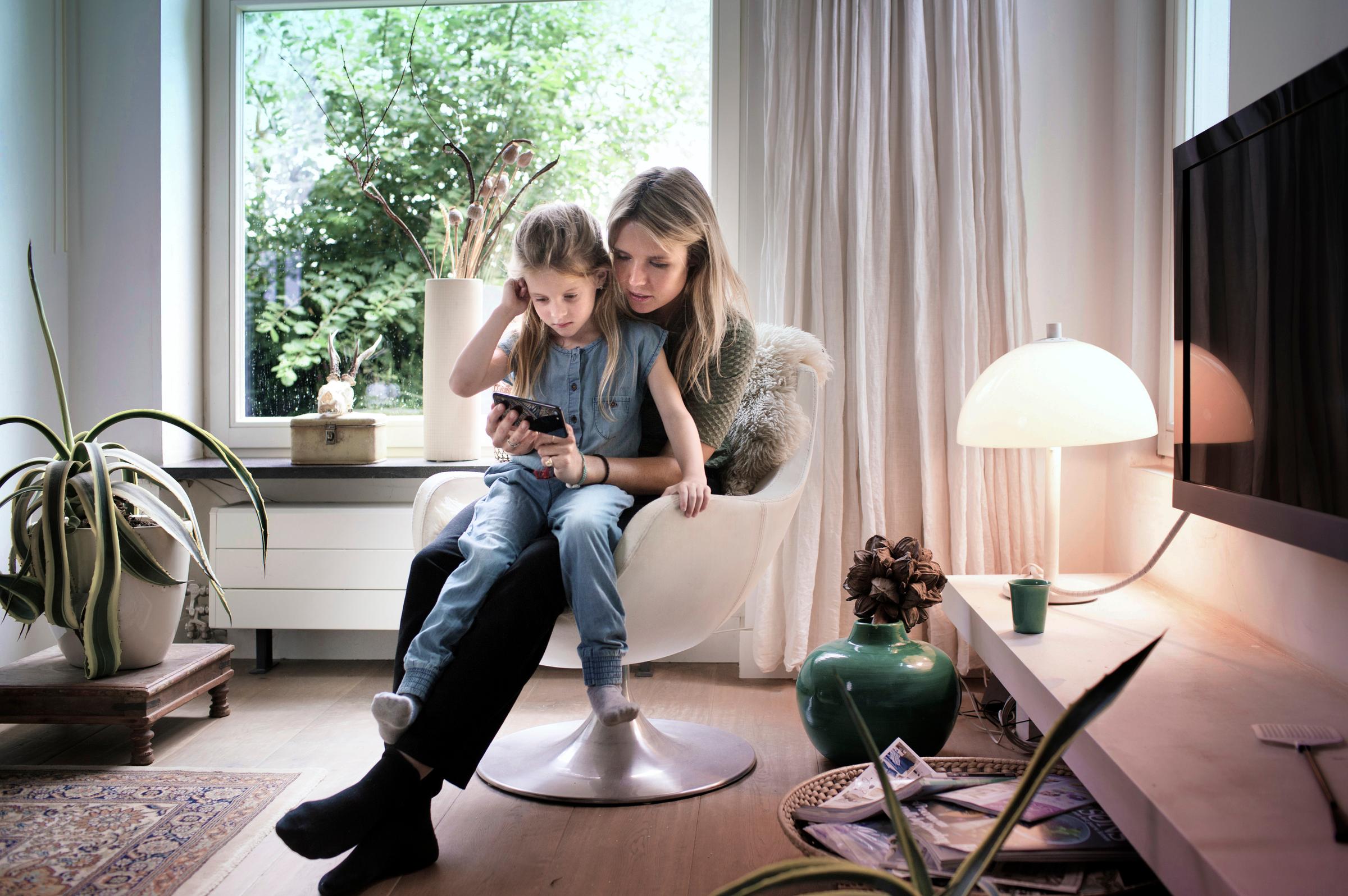 Mother and daughter with phone