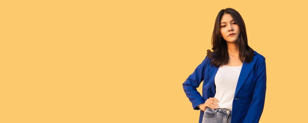 Woman with blue suit in front of yellow background