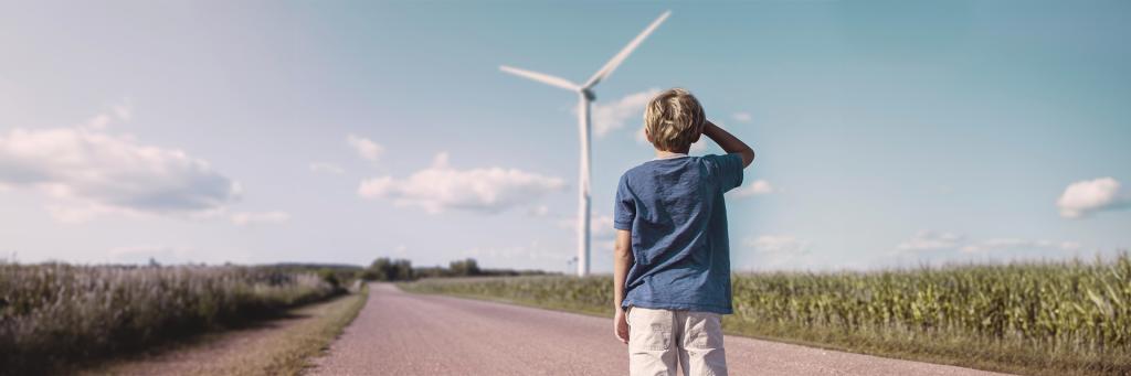 Boy looking at a wind turbine