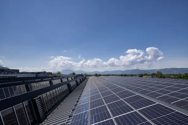 A solar park under a blue sky representing solar-powered lighting. 