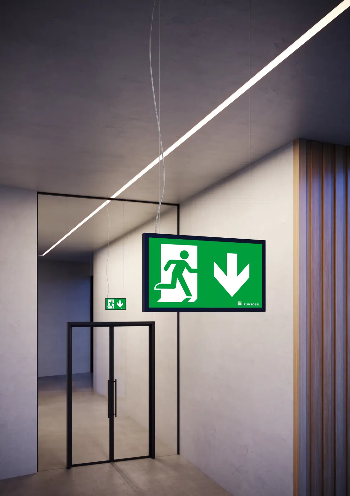 Nahaufnahme von zwei SMARTSIGN Rettungszeichenleuchten von Zumtobel in einem modernen Flur, getrennt durch eine Glastür – elegante Integration in die Architektur.