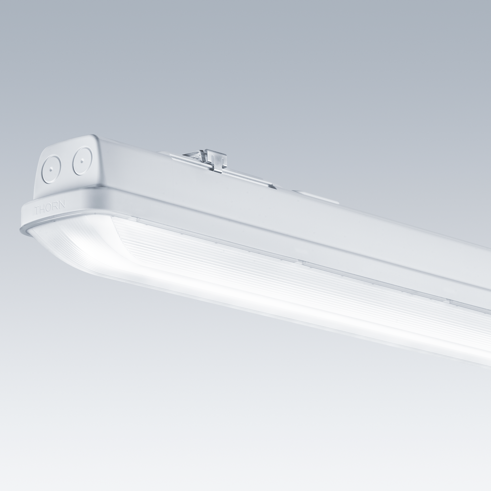A sleek white LED ceiling light fixture with a rectangular design and rounded edges. The fixture is set against a gradient gray background, showcasing its minimalist and durable design for industrial or commercial use.