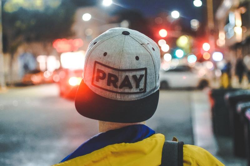 man-with-slogan-cap-pray