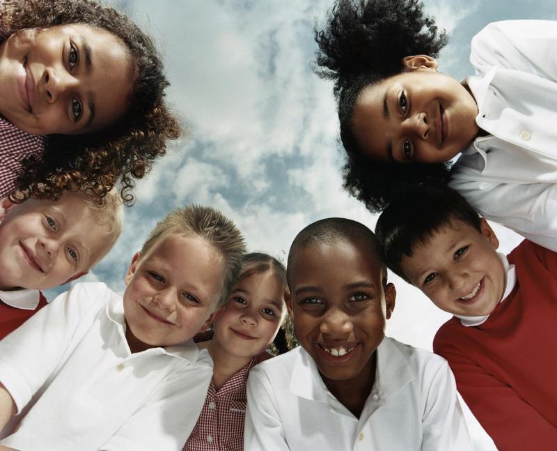 children-smiling-clouds-behind