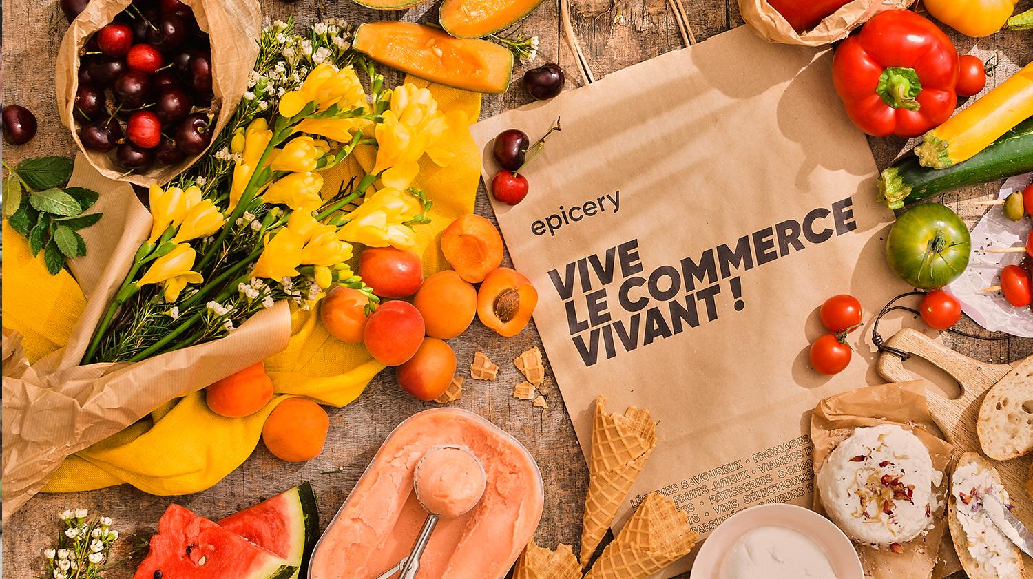 Fruits et légumes frais variés, pain compris, avec texte 'VIVE LE COMMERCE VIVANT!' sur le sac.