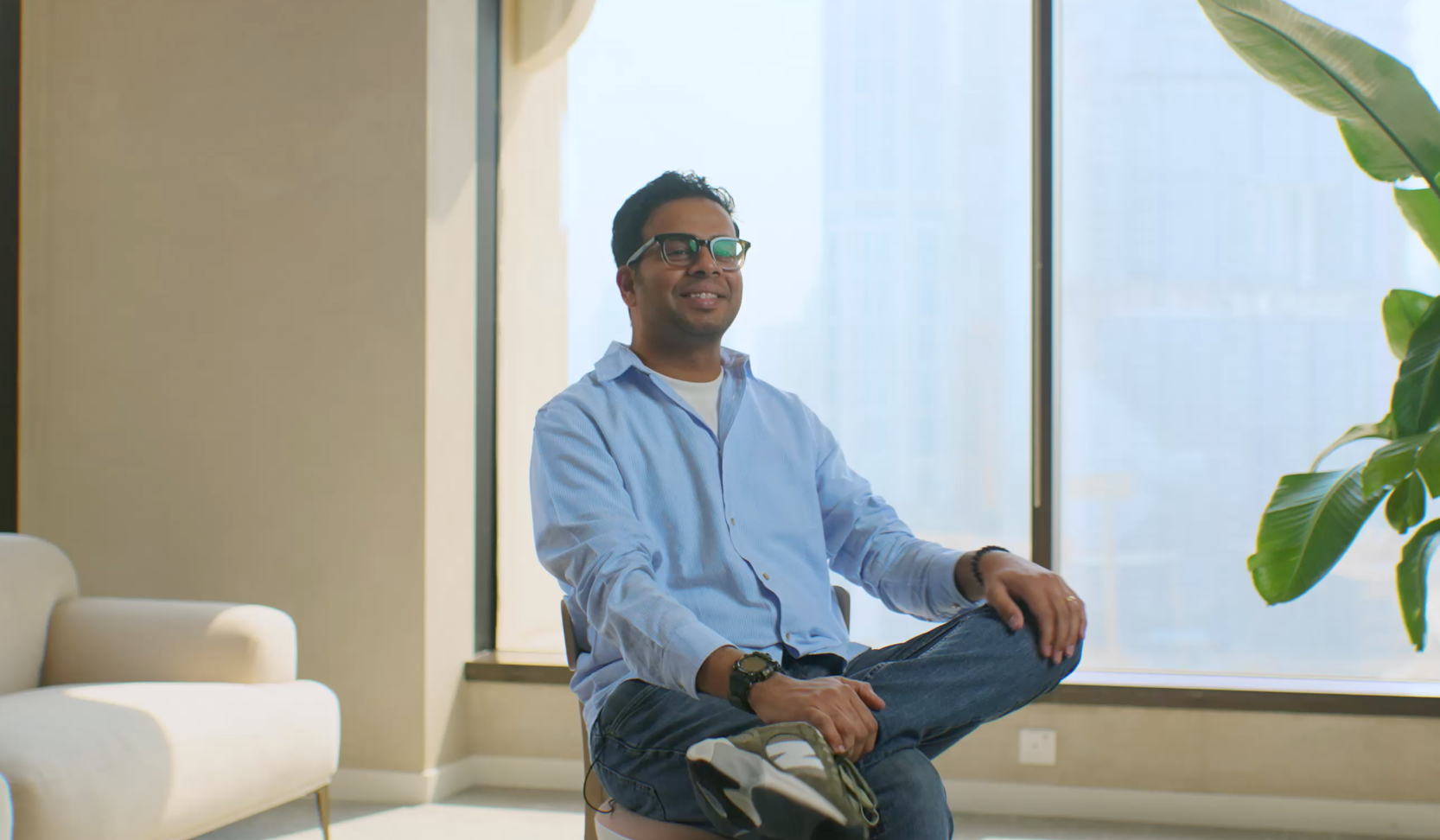 Adyen employee in the Adyen office meditating near a window with a payment terminal visible
