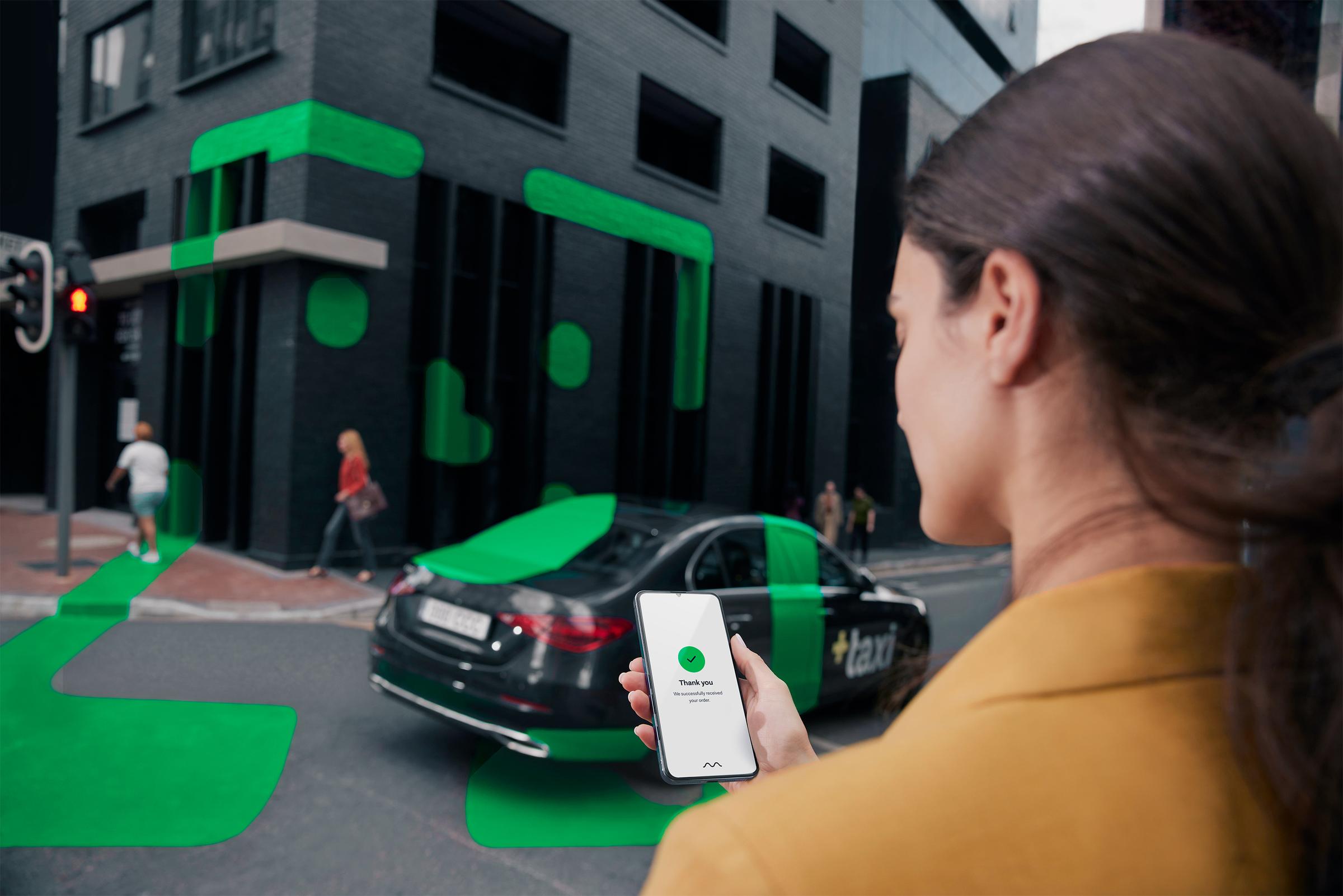 Woman viewing ride hailing app on phone