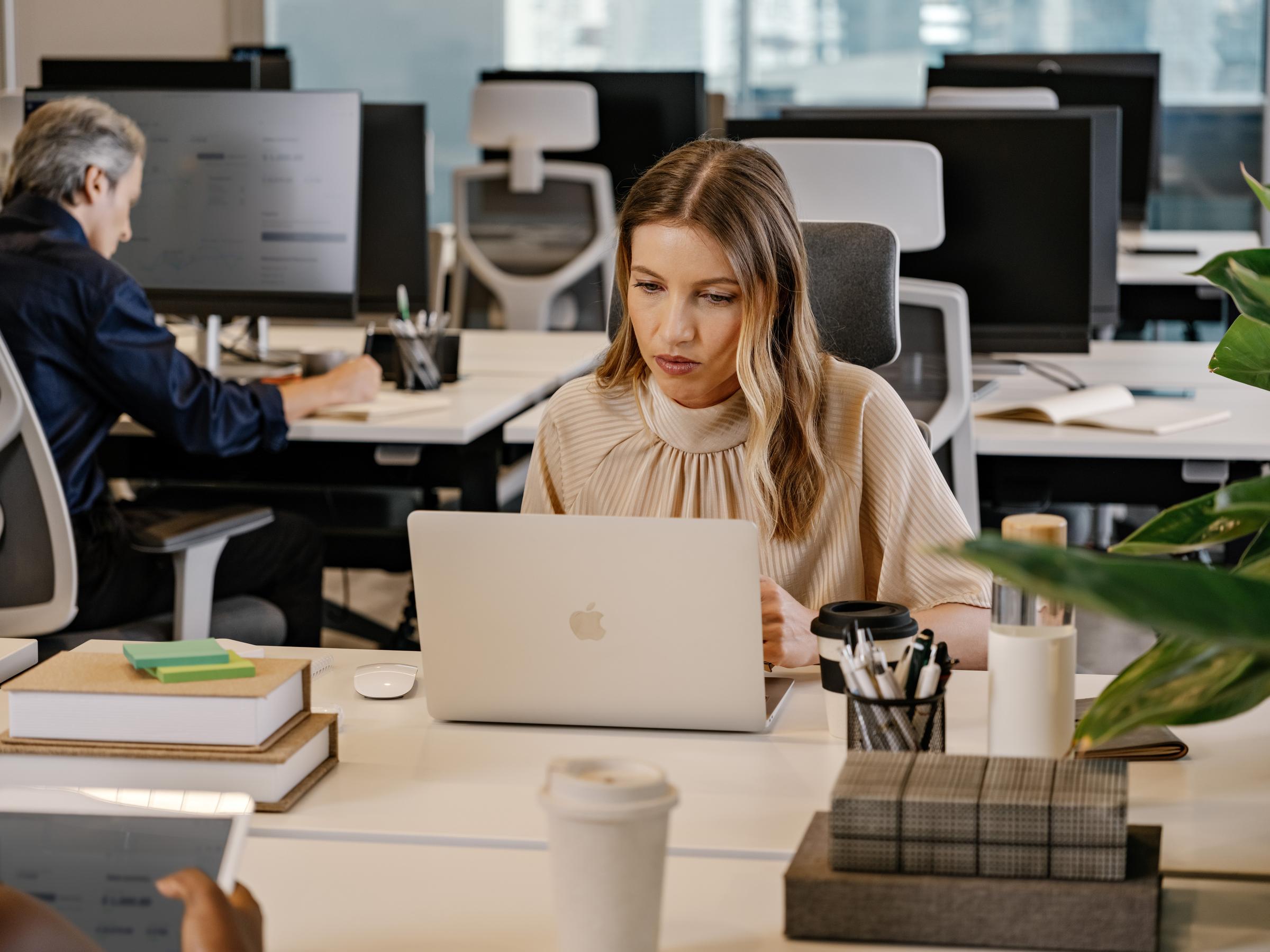 woman working behind a laptop