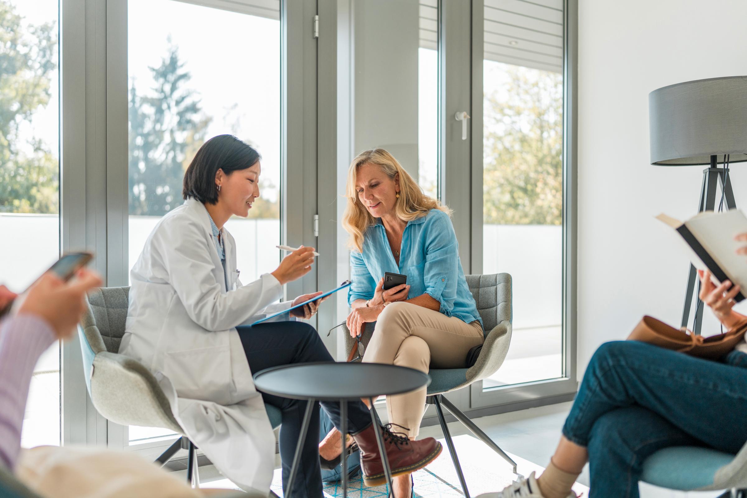 A patient and a dentist in the dental office discussing dental treatment options.