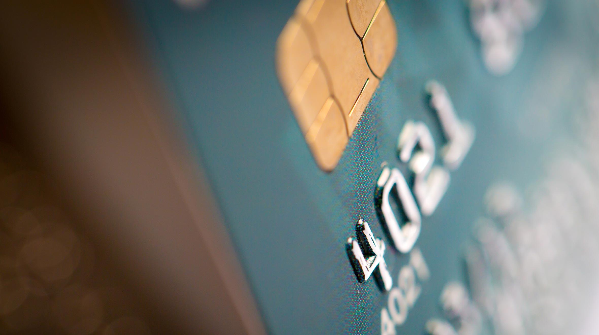 Close-up view of a credit card showing partial card number and chip.