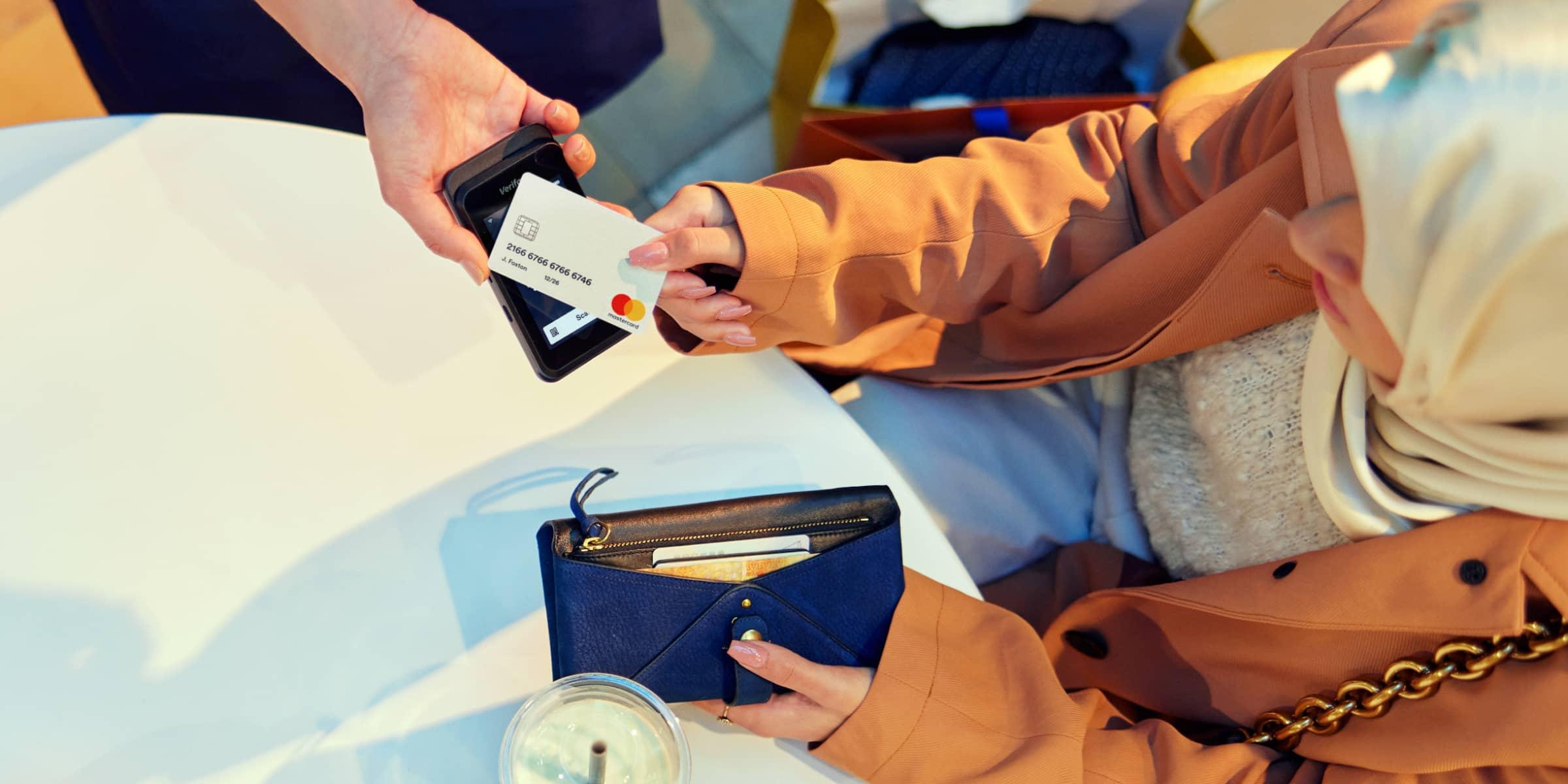 Customer using a contactless card with an Adyen payment terminal.
