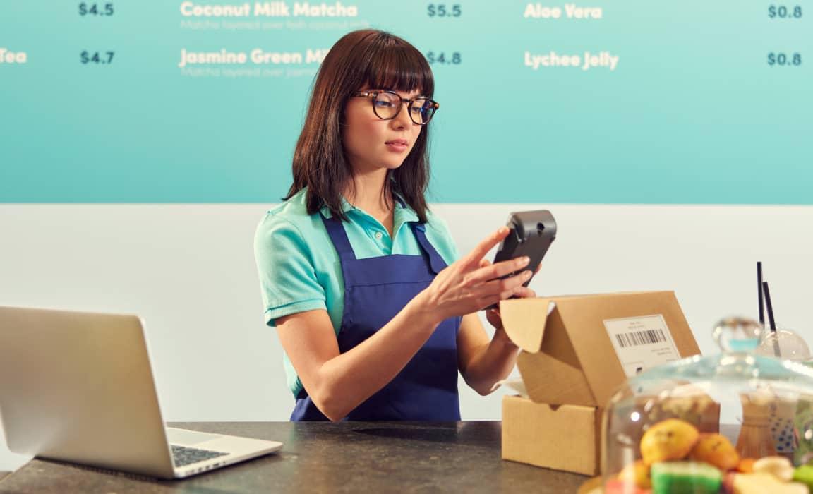 Woman setting up terminal in restaurant