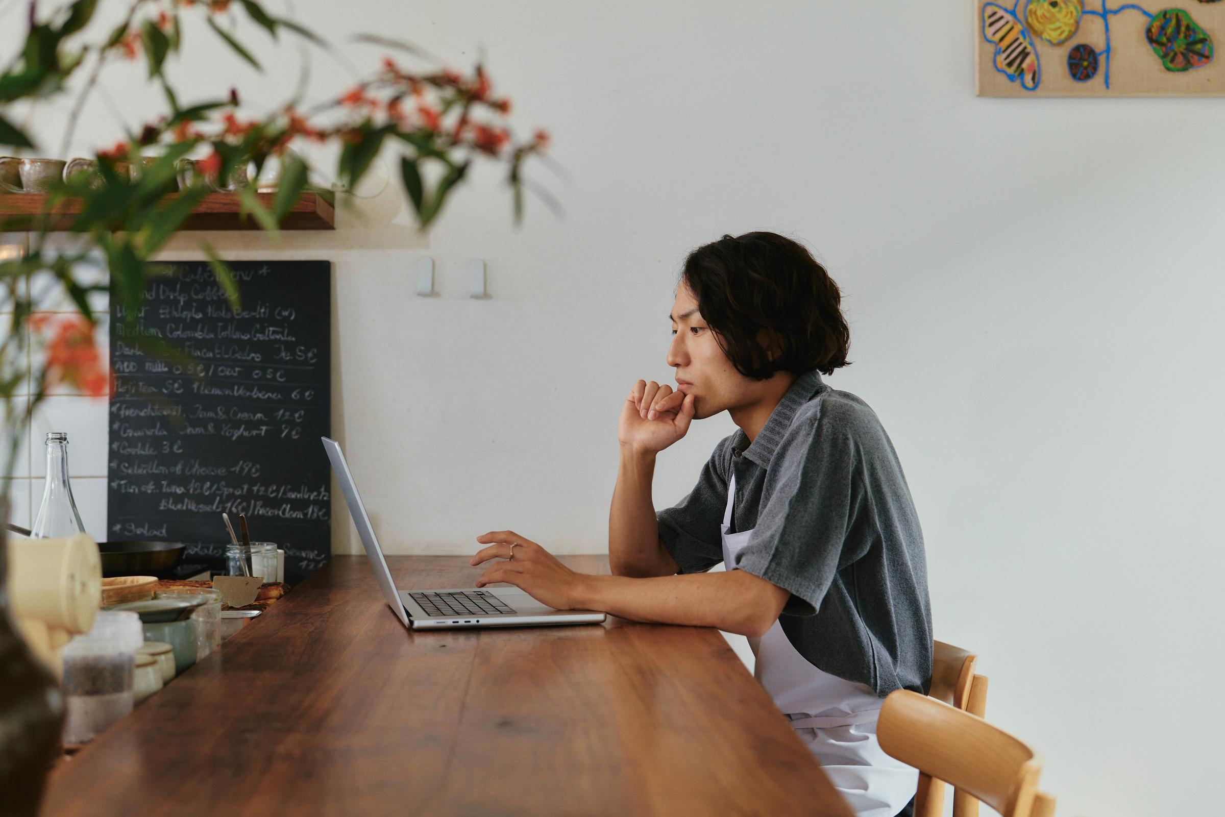 Restaurant owner on laptop using a SaaS platform