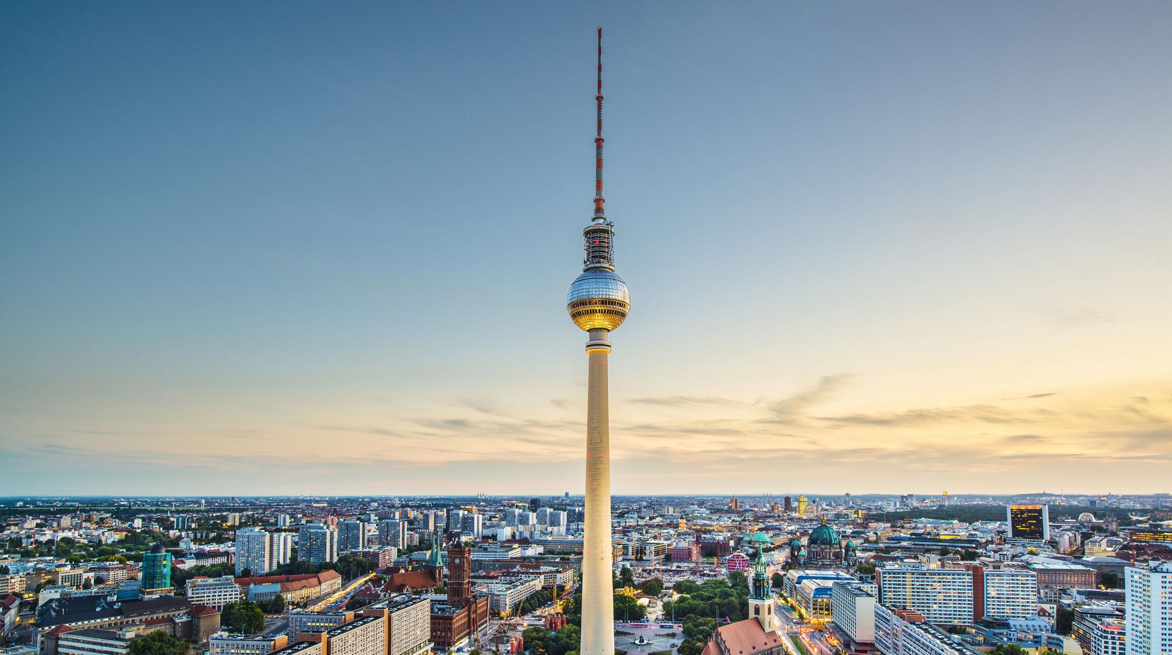 Aerial view of Berlin skyline with television tower at sunset.