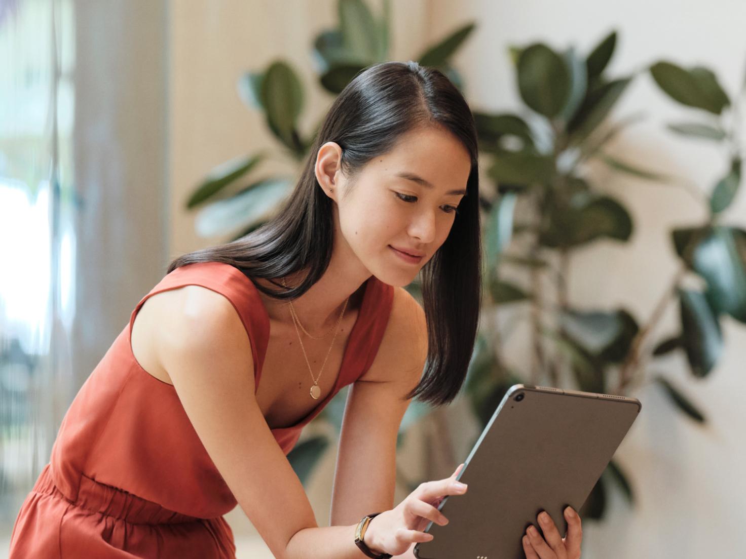 A woman reading on her tablet