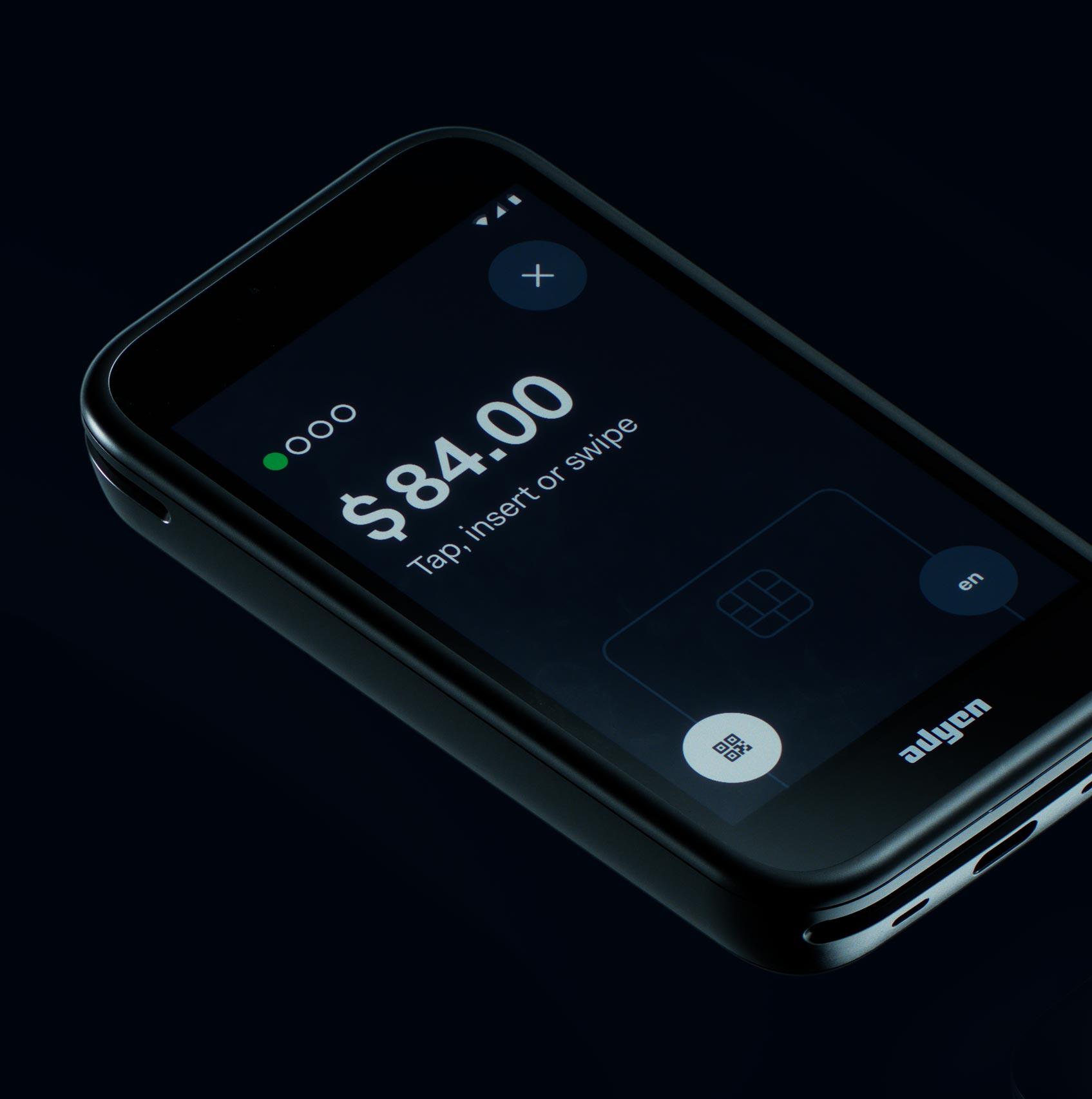 Smartphone displaying Adyen payment screen with a transaction amount of $84.00.