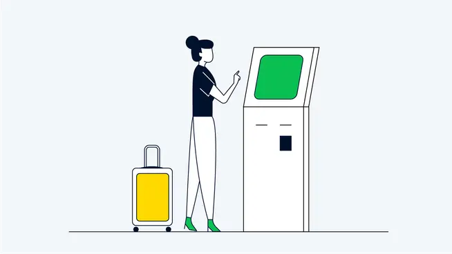 Person with luggage using a self-service kiosk